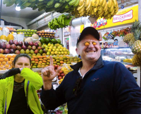 Learn More than Spanish Students visiting one of Bogota's tasting different exotic fruits from Colombia in a local market