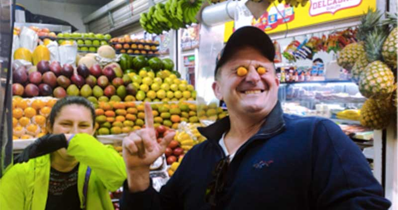 Learn More than Spanish Students visiting one of Bogota's tasting different exotic fruits from Colombia in a local market