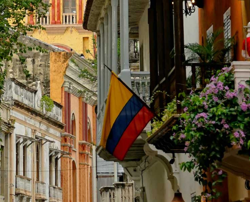 Colombian flag in a window with flowers. Is Colombian Spanish really the world’s best?