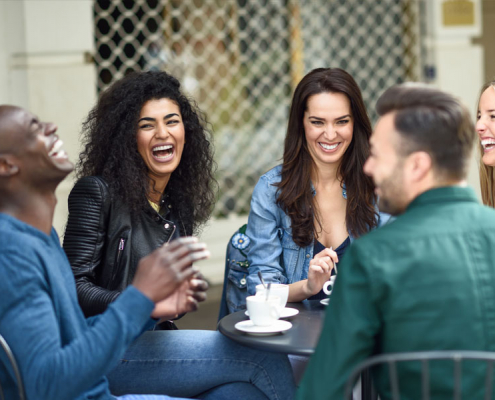 Group of people enjoying coffee outside and having a good time