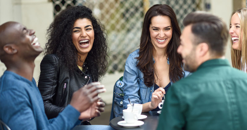 Group of people enjoying coffee outside and having a good time
