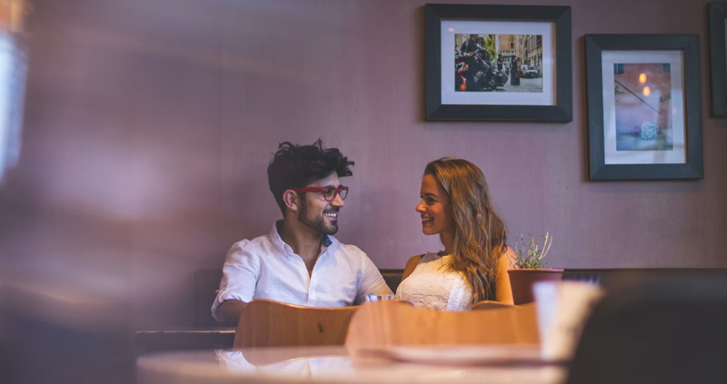 Happy couple in a date at a restaurant.