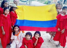 Wayuu culture Colombia. A group of Wayuu people holding the Colombian flag.