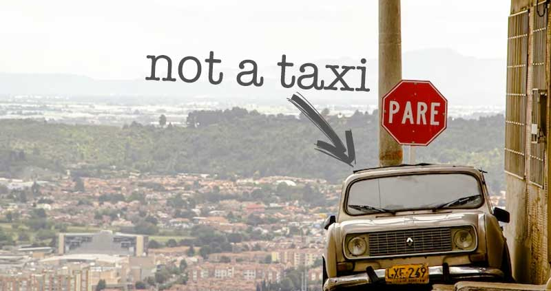 A Car in Bogotá, Colombia, the photo has the text "not a taxi" The Best Way to Navigate Bogotá's Public Transport while learning Spanish.