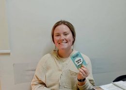 A smiling student learning Colombian Spanish at a Spanish school in Bogotá during a beginner Spanish class