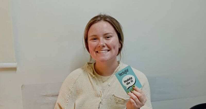 A smiling student learning Colombian Spanish at a Spanish school in Bogotá during a beginner Spanish class